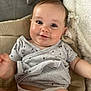 baby, infant, smile, face, eyes, onesie, diaper, blanket, cute, child, skin, arm, hand, head, comfort, lying_down, expression, indoor, clothing, young