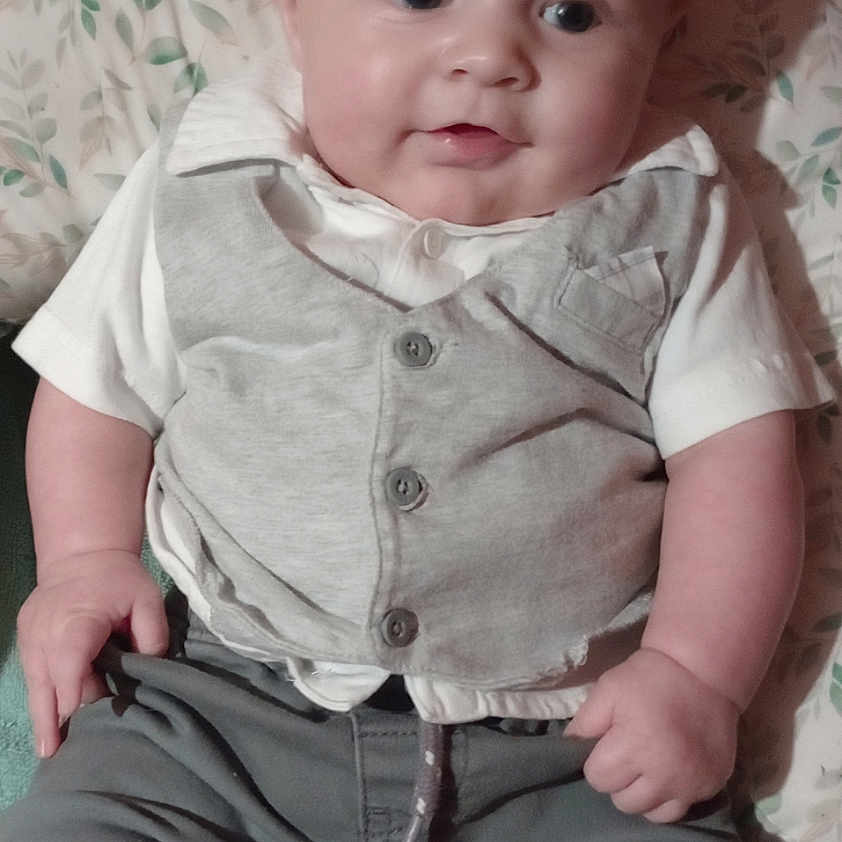 Leyland joined the competition — help win amazing prizes! baby, child, infant, clothing, vest, pants, toy, colorful_toy, egg_shaped_toy, cushion, floral_pattern, indoor, portrait, sitting, smiling, cute, person, face, hand, foot