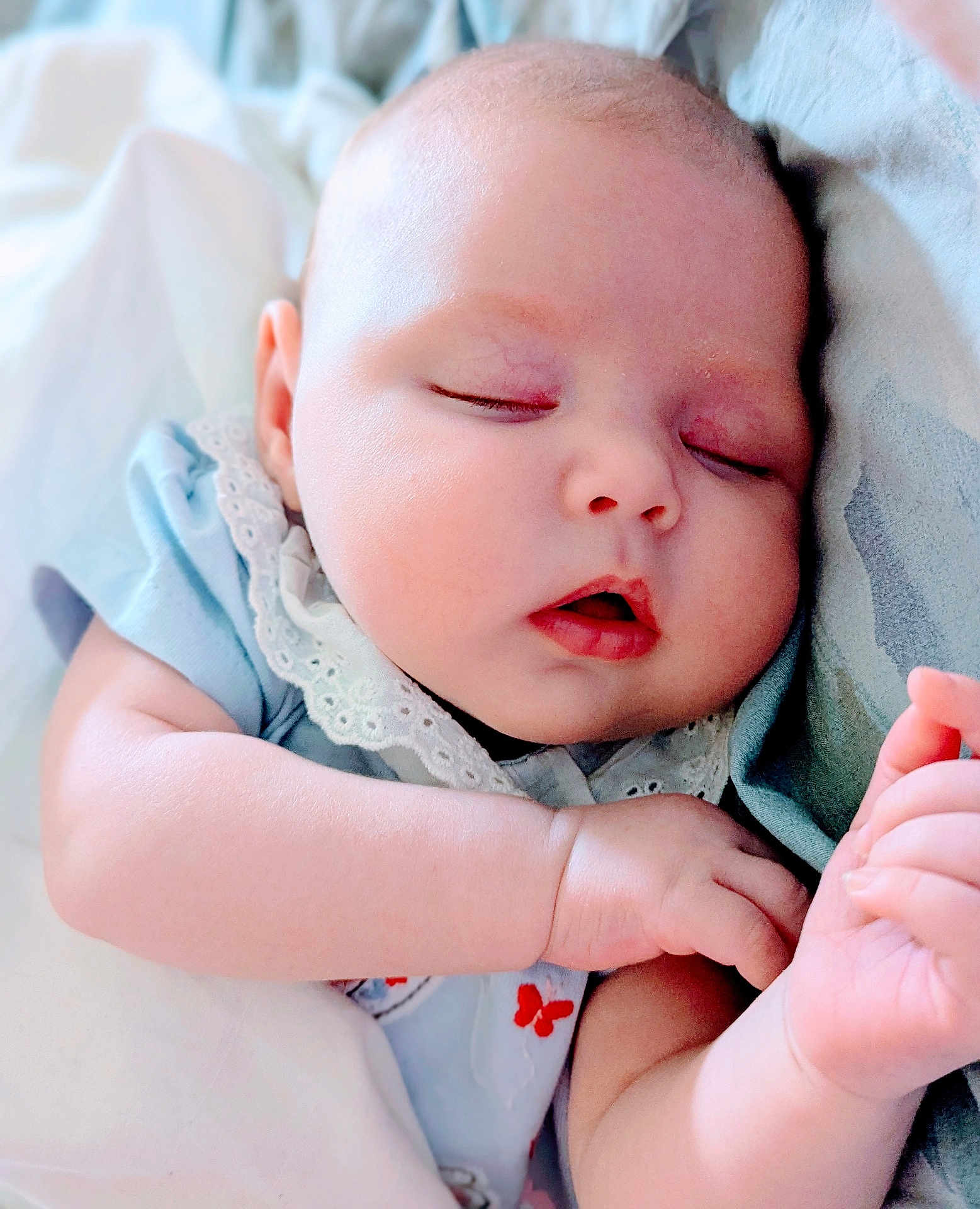Lola joined the competition — help win amazing prizes! baby, sleeping, infant, peaceful, soft, blanket, blue_clothing, lace, red_butterflies, closeup, face, cheeks, hand, nap, cute, skin, young_child, indoors, portrait, resting