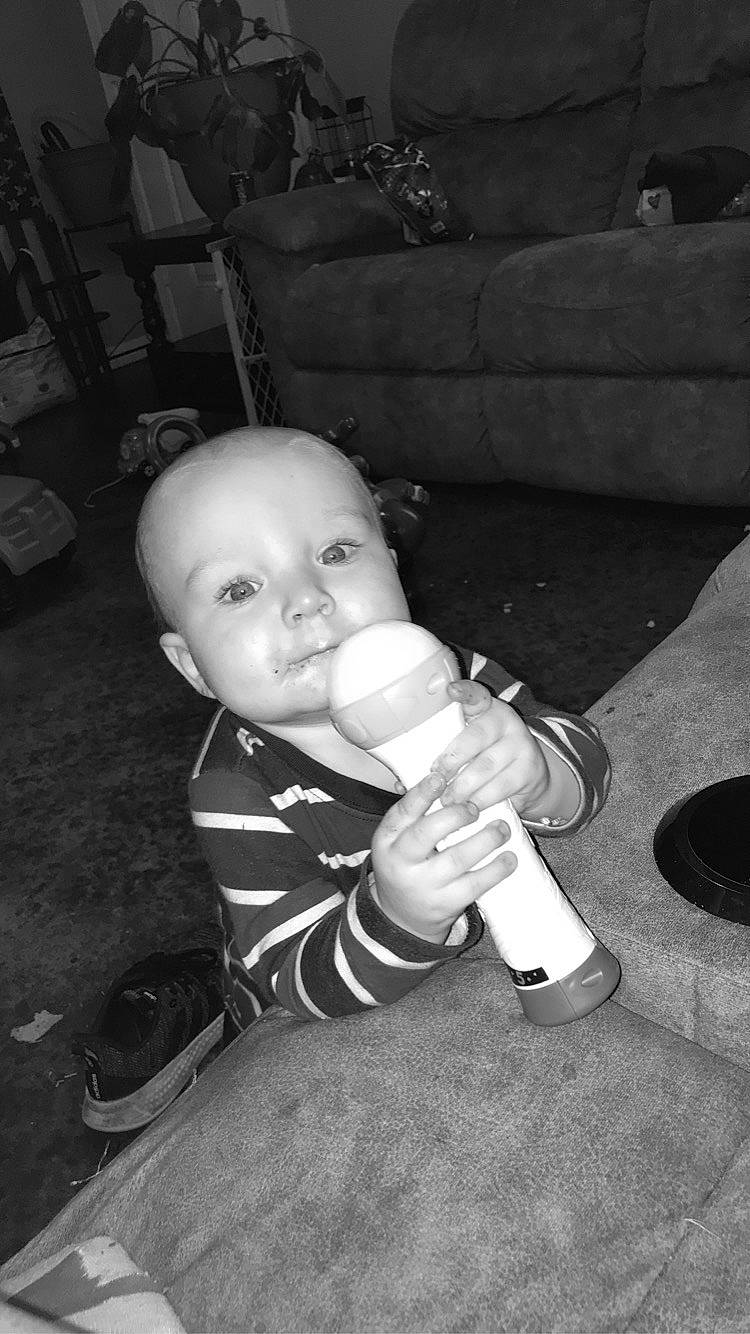 Luke Ashelie joined the competition — help win amazing prizes! baby, baby_toddler_clothing, black_and_white, cheek, child, comfort, couch, darkness, drinkware, flash_photography, fun, gesture, head, monochrome, monochrome_photography, person, room, sitting, stock_photography, style