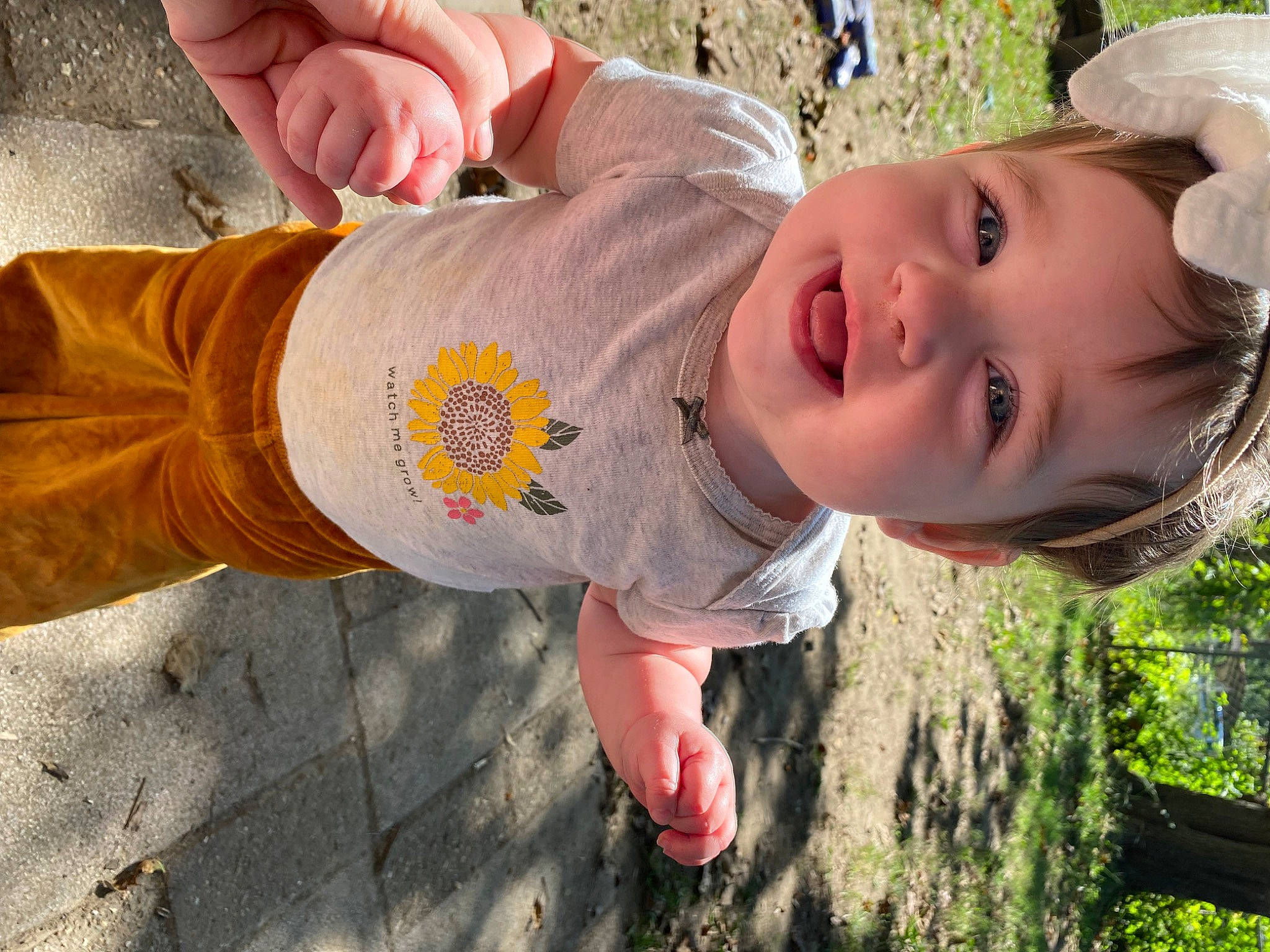 Oaklyn is registered to the contest to win money with this photo: adaptation, finger, fun, grass, hand, happy, hat, head, leisure, mouth, nature, nose, people_in_nature, person, plant, skin, smile, sun_hat, toddler, tree