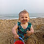 beach, blue_eyes, bucket, child, fun, happy, nature, ocean, outdoor, playing, sand, sandcastle, smile, summer, sunlight, swimsuit, toddler, vacation, water, waves