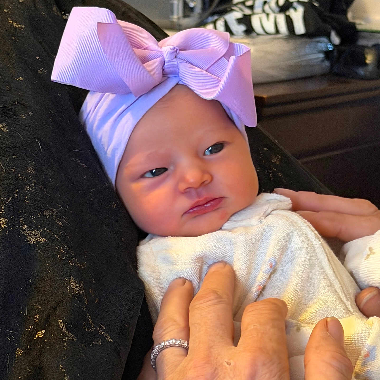 Delaine joined the competition — help win amazing prizes! baby, bedroom, blanket, bow, clothing, cozy, expression, face, fingers, gentle, hand, headwear, indoor, infant, newborn, person, portrait, ring, skin, soft