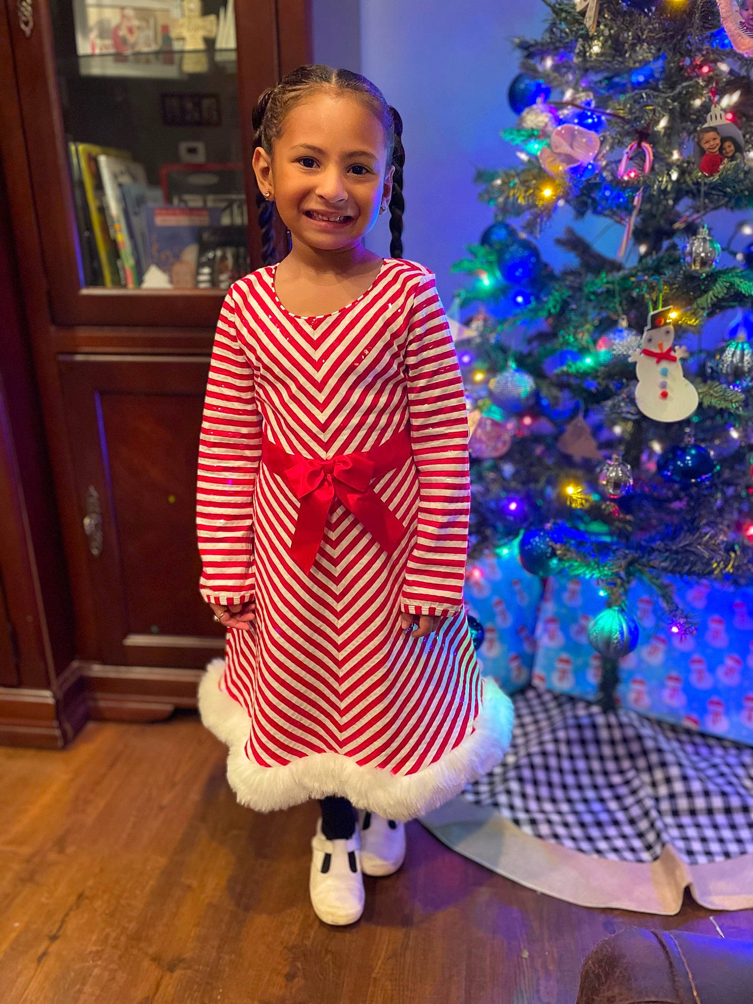 Emaleigh joined the competition — help win amazing prizes! baby_toddler_clothing, blue, christmas, christmas_ornament, christmas_tree, electric_blue, event, fun, happy, holiday, holiday_ornament, joy, light, ornament, person, purple, sleeve, smile, standing, toddler