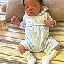 Arthur joined the competition — help win amazing prizes! baby, infant, child, romper, white_socks, cushion, striped_fabric, beige_pillow, indoor, person, newborn, cute, clothing, resting, small_hands, face, legs, footwear, soft_texture, lying_down