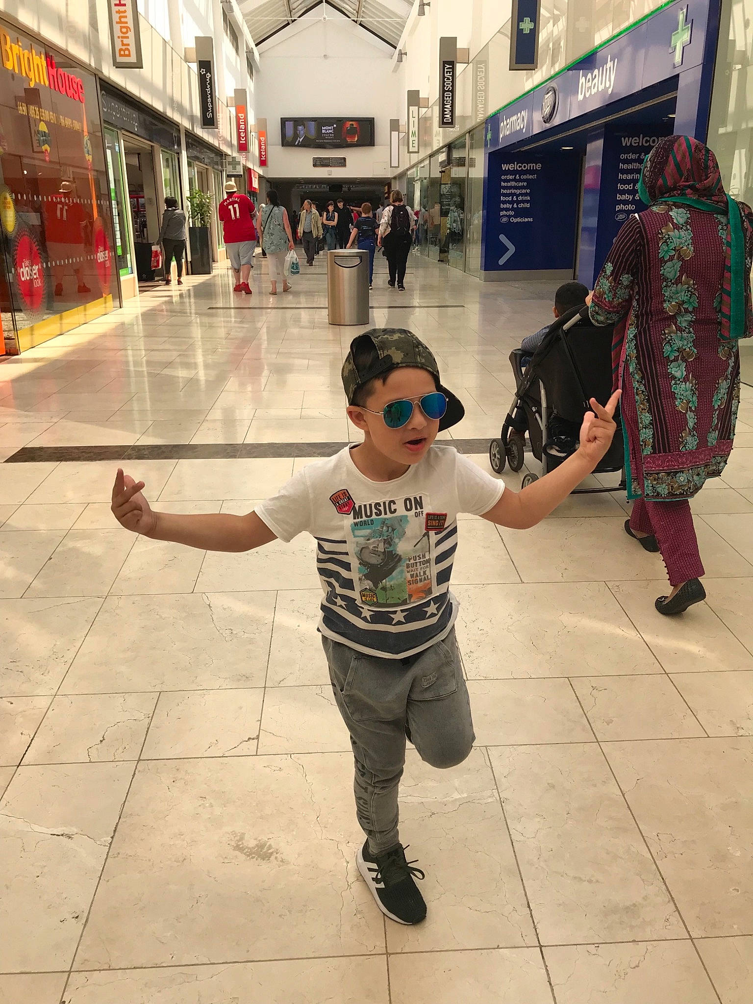 Nicolas is registered to the contest to win money with this photo: child, cool, eyewear, footwear, fun, glasses, human, infrastructure, male, pedestrian, people, person, photograph, photography, snapshot, standing, street, sunglasses, toddler, vacation