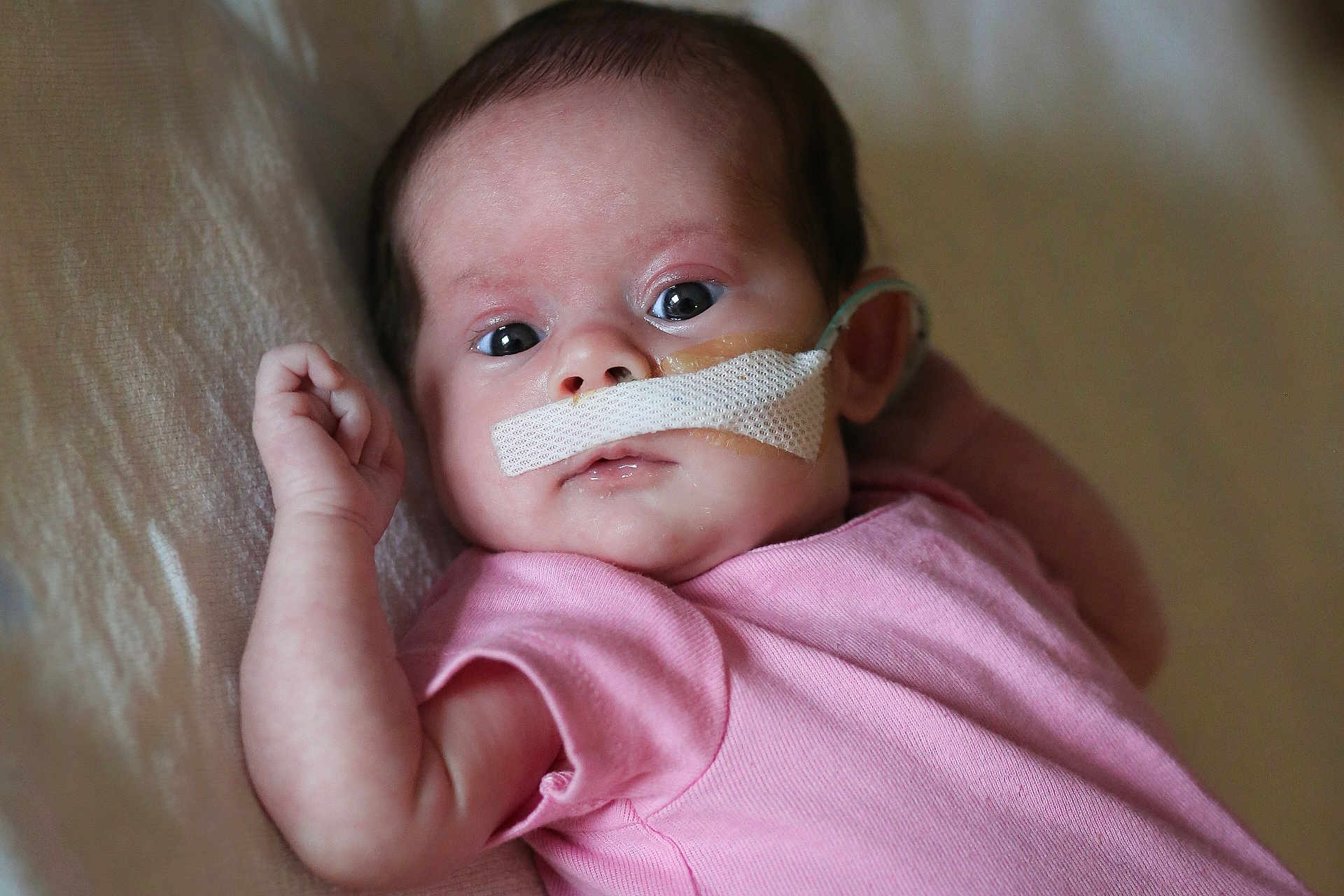 Hazel joined the competition — help win amazing prizes! baby, infant, face, pink_clothing, lying_down, medical_tube, nasal_tube, tape, skin, eyes, hand, newborn, portrait, bed, soft_surface, cute, healthcare, hospital, patient, closeup
