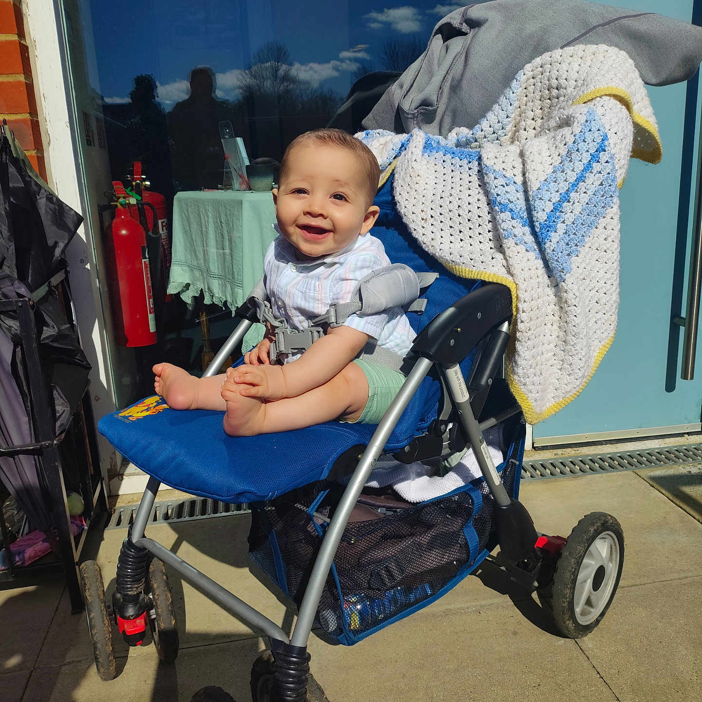 Elroi is registered to the contest to win money with this photo: adult, architecture, baby, building, candle, desk, face, female, furniture, head, machine, outdoors, person, photography, portrait, shelter, stroller, table, wheel, woman