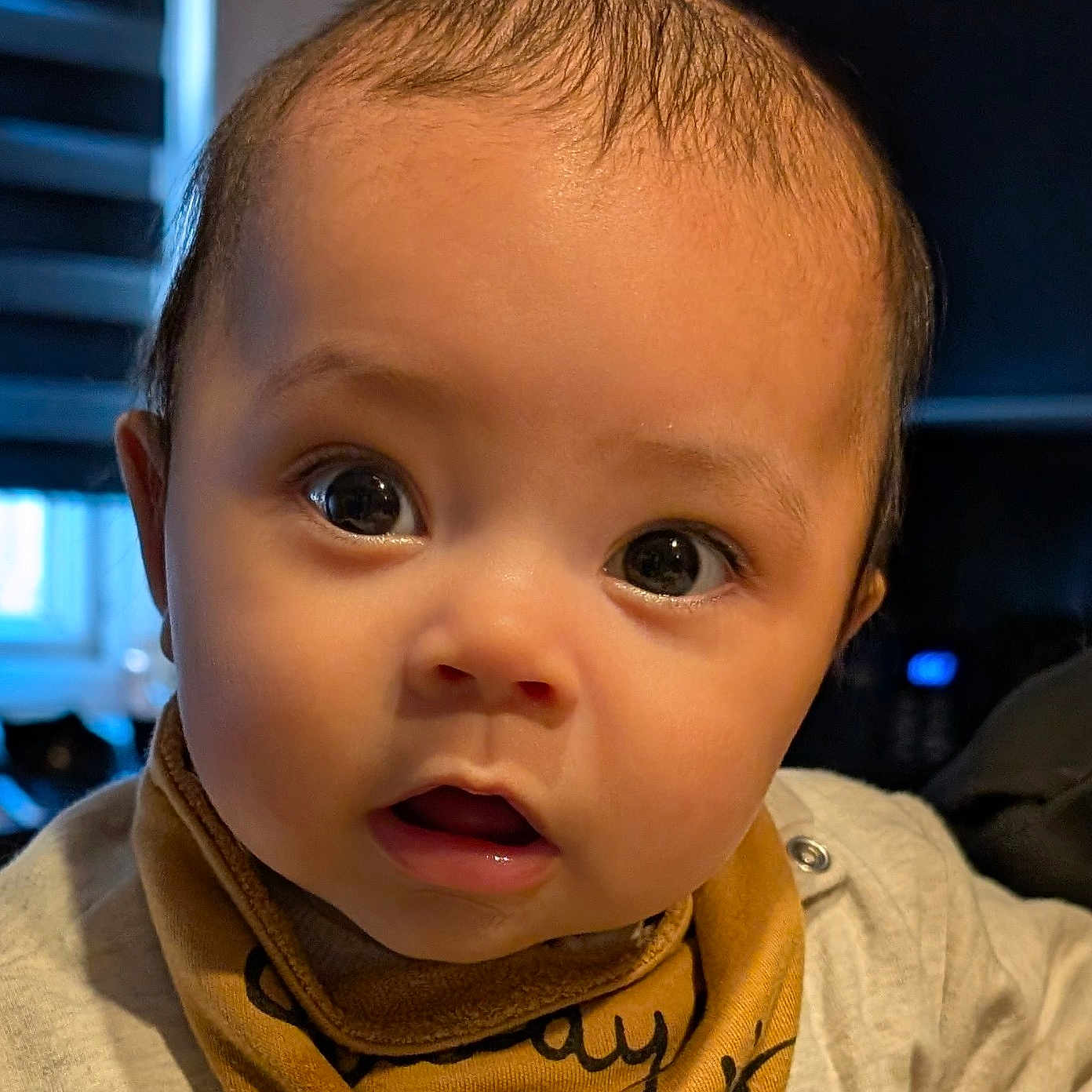 Sheridan is registered to the contest to win money with this photo: adorable, baby, bib, child, closeup, clothing, curious, cute, expression, eyes, face, head, human, indoors, infant, mouth, person, portrait, skin, young