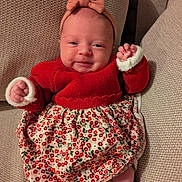 Ambre participe au concours pour gagner de l'argent avec cette photo : baby, infant, smile, headband, red_sweater, floral_skirt, couch, knitwear, cozy, cute, child, portrait, indoors, happy, small_hands, head, legs, feet, fabric, seated
