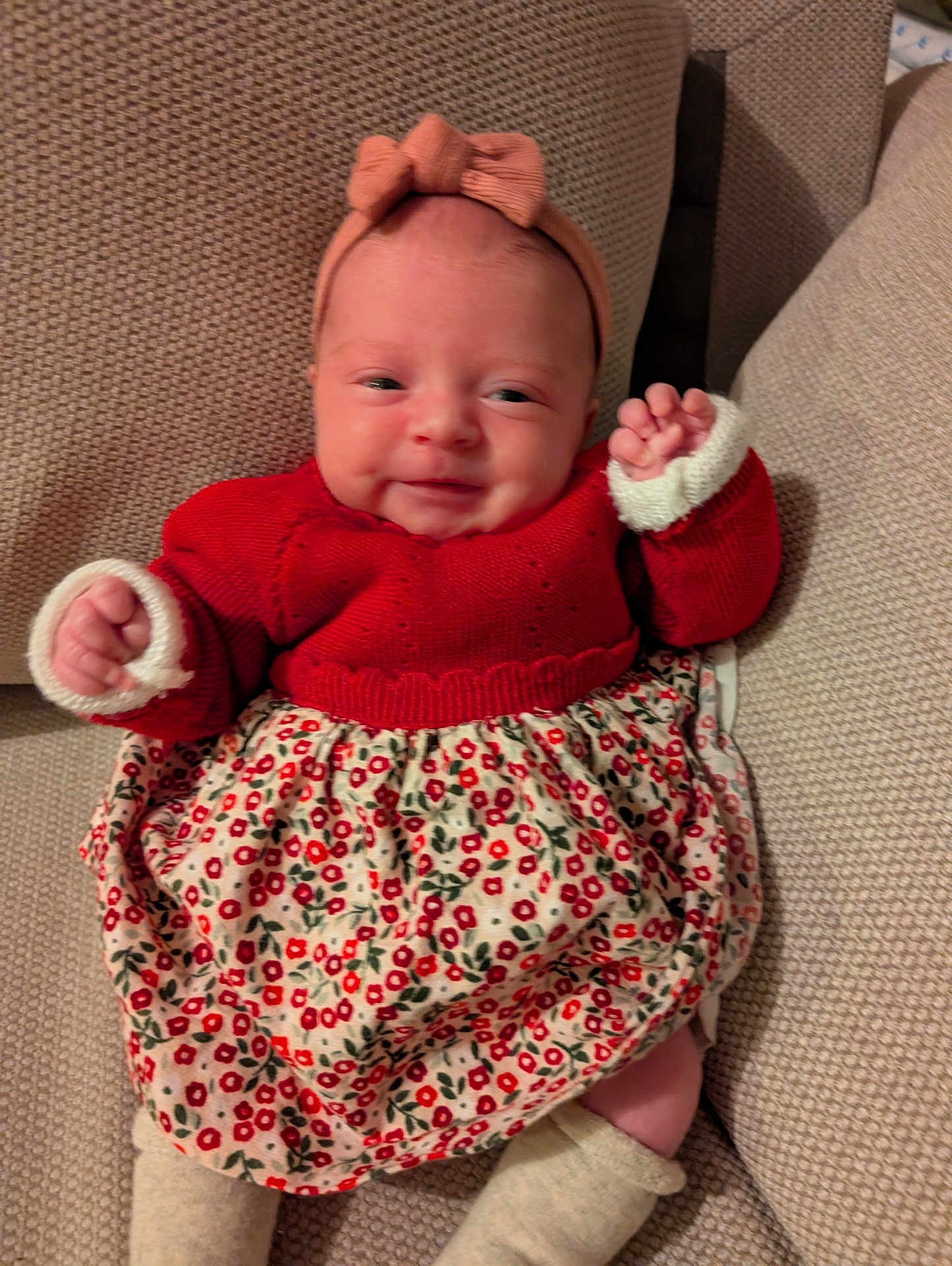 Ambre participe au concours pour gagner de l'argent avec cette photo : baby, infant, smile, headband, red_sweater, floral_skirt, couch, knitwear, cozy, cute, child, portrait, indoors, happy, small_hands, head, legs, feet, fabric, seated