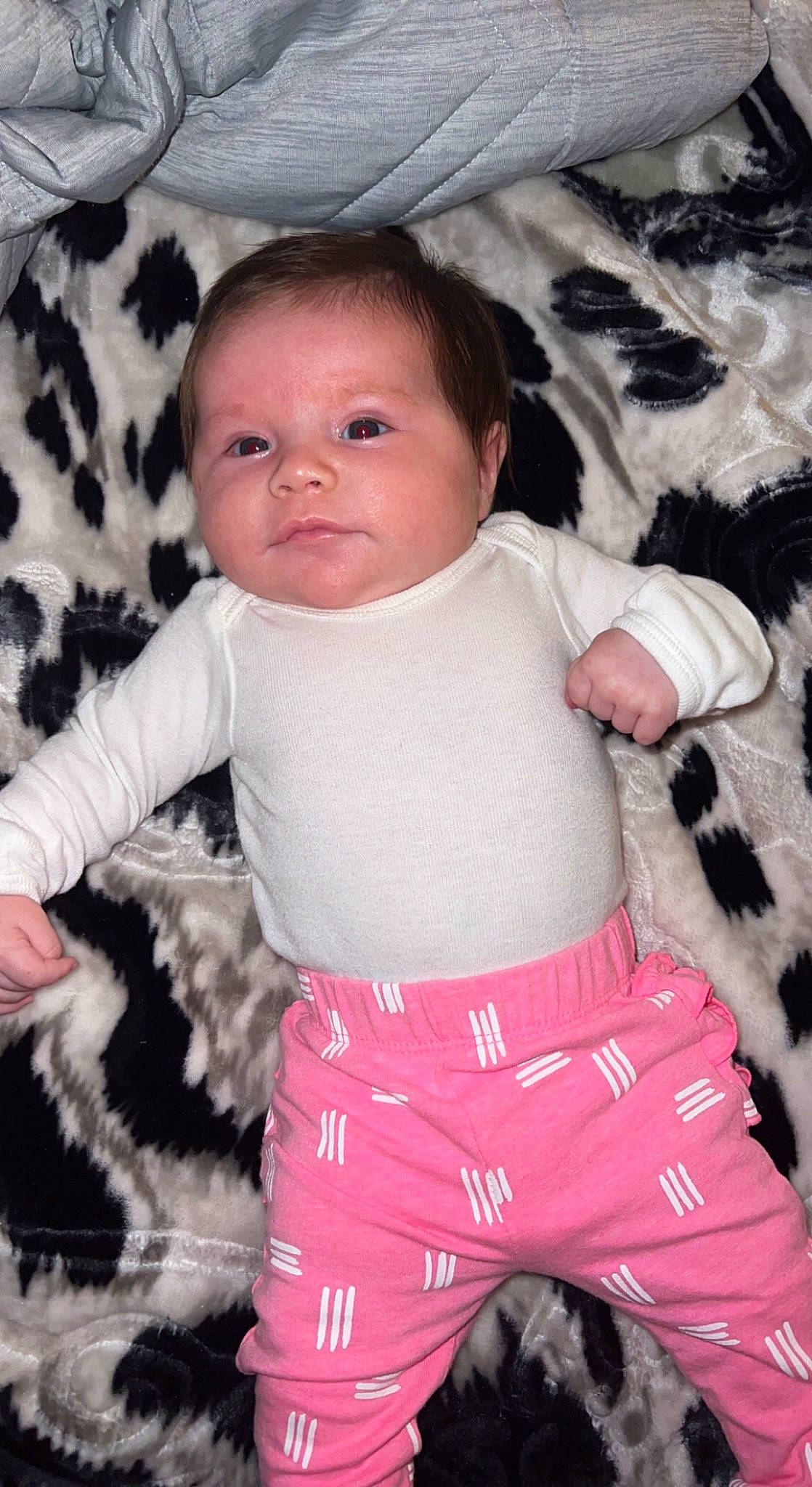 Sienna is registered to the contest to win money with this photo: baby, baby_toddler_clothing, cheek, child, comfort, cool, finger, fun, gesture, happy, head, linens, pattern, person, pink, skin, sleeve, t_shirt, thigh, toddler