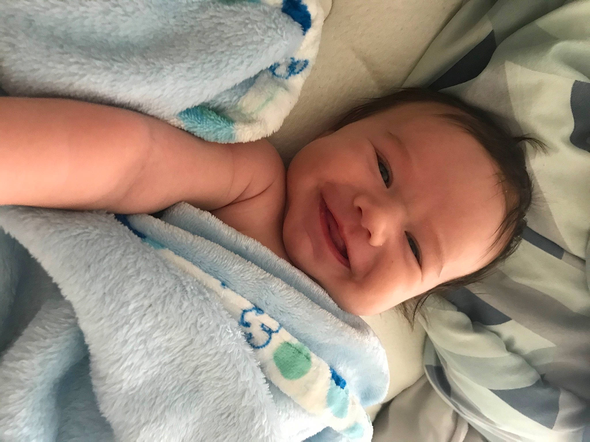 Alonzo is registered to the contest to win money with this photo: baby, baby_toddler_clothing, cheek, child, close_up, comfort, eye, eyebrow, face, finger, gesture, happy, head, iris, joy, linens, nose, person, skin, smile