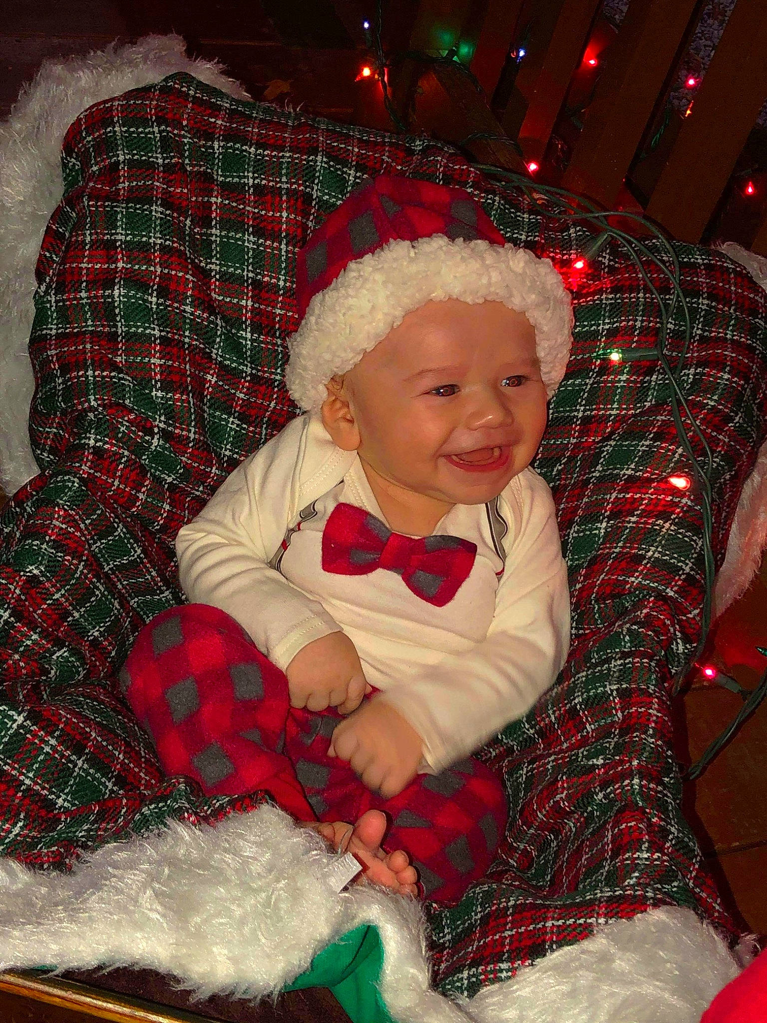 Alonzo joined the competition — help win amazing prizes! baby_toddler_clothing, cheek, christmas_decoration, christmas_ornament, comfort, eye, green, human_body, joy, lap, organ, pattern, person, plaid, red, santa_claus, sleeve, smile, tartan, textile