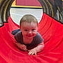baby, child, smiling, crawling, play_tunnel, red, indoor, gym, floor, toddler, happy, cute, person, play, fabric, head, hand, clothing, young, fun