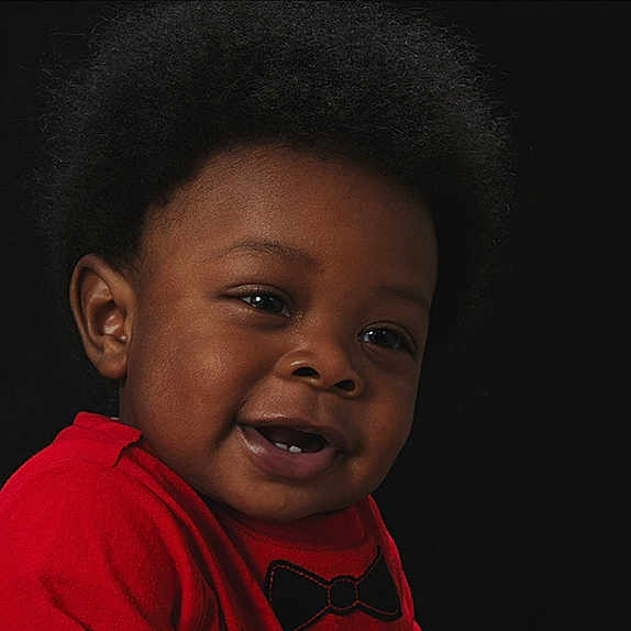 Demetrius is registered to the contest to win money with this photo: black_hair, boy, cheek, child, chin, emotion, eye, face, facial_expression, forehead, girl, head, human, lip, nose, organ, person, smile, temple, toddler