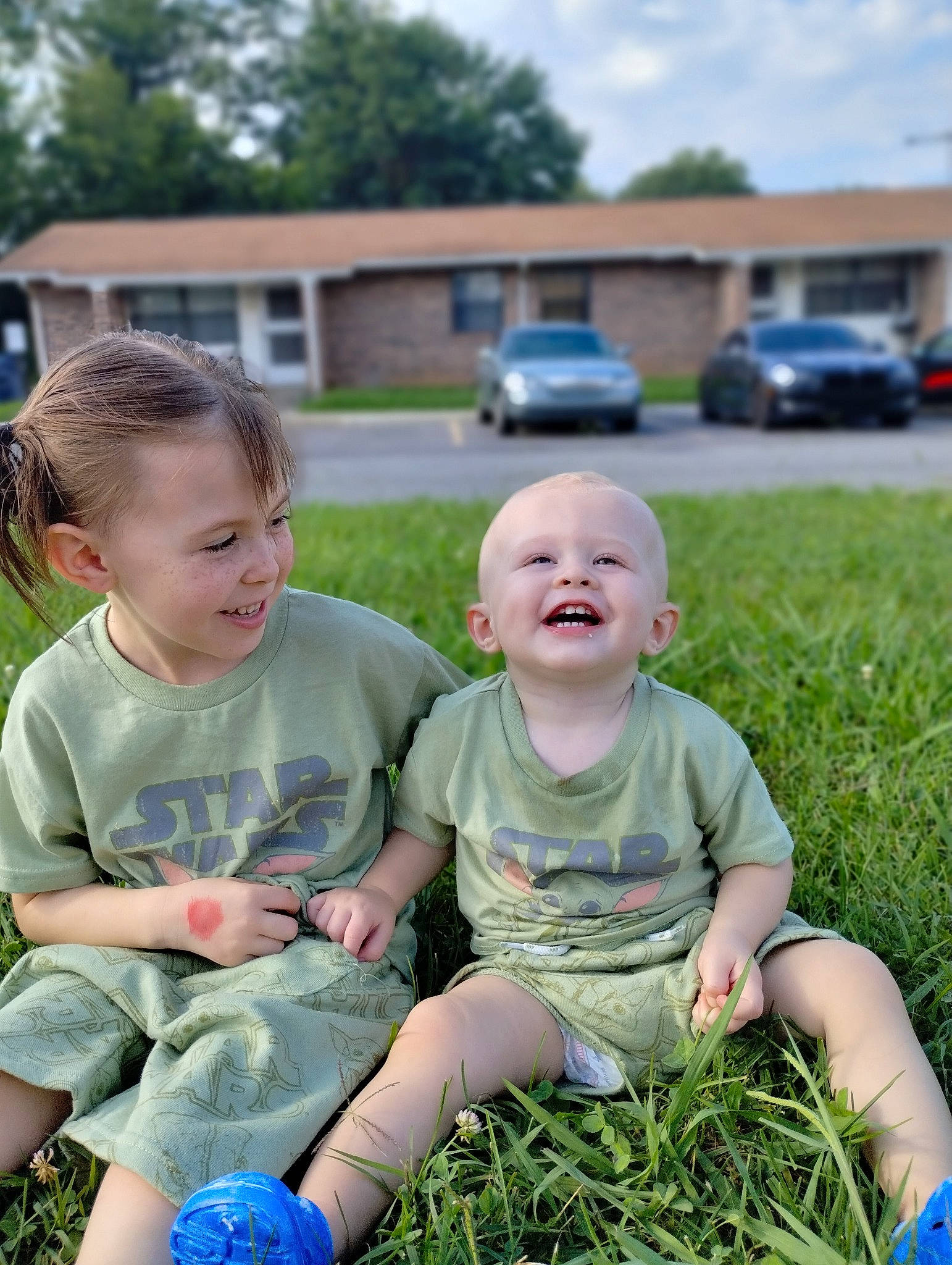 Parker is registered to the contest to win money with this photo: baby, baby_toddler_clothing, car, face, facial_expression, fun, grass, grassland, happy, joy, lawn, leisure, meadow, people_in_nature, person, plant, recreation, shorts, smile, t_shirt