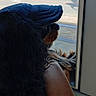 dog, cap, window, seat, black_dog, looking_outside, indoor, resting, side_view, brown_seat, animal, pet, fur, portrait, calm, canine, travel, daylight, reflection, casual