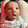 Kamari joined the competition — help win amazing prizes! baby, infant, tongue_out, onesie, clothing, person, legs, skin, hand, face, eyes, indoor, champion_logo, cute, expression, newborn, child, closeup, portrait, human