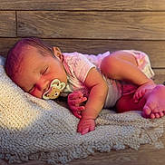 Kamari joined the competition — help win amazing prizes! baby, newborn, sleeping, pacifier, blanket, wood_floor, infant, cute, peaceful, small_hands, small_feet, clothing, lying_down, indoors, soft_lighting, skin, head, relaxation, child, toddler