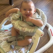 Lincoln Morales joined the competition — help win amazing prizes! baby, smiling, winking, baby_walker, striped_clothing, socks, wooden_floor, child, happy, infant, seated, indoor, playful, cute, person, young_child, fabric, pattern, footwear, toy