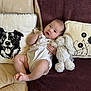 Romy a rejoint le concours — aidez-le/la à gagner de superbes lots ! baby, infant, plush_toy, bunny, couch, pillow, blanket, leather, child, cute, smiling, indoors, relaxing, soft_toy, decor, comfort, portrait, young_child, sitting, happy