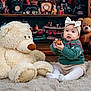 Romy a rejoint le concours — aidez-le/la à gagner de superbes lots ! baby, child, teddy_bear, toy, plush, ornament, christmas, holiday, sweater, headband, carpet, indoor, decorations, gift, cute, festive, floor, smiling, person, seasonal