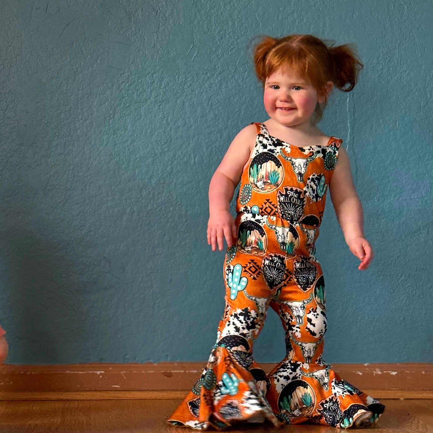 Octavia is registered to the contest to win money with this photo: child, clothing, dress, face, female, footwear, formalwear, furniture, girl, hardwood, head, pajamas, pants, person, photography, portrait, sandal, sleeve, suit, wood