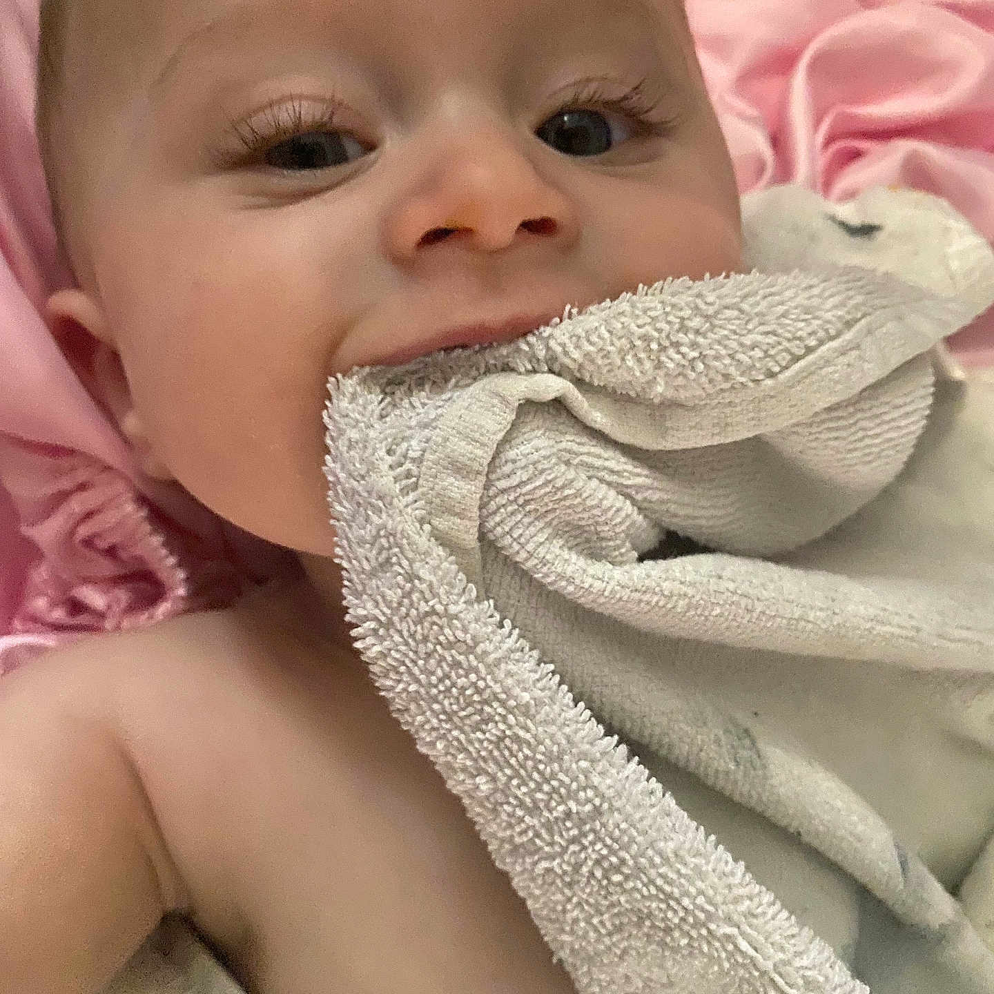 Oliver is registered to the contest to win money with this photo: baby, blanket, chewing, child, closeup, comfort, cute, eyelashes, face, infant, lying_down, newborn, pink, playful, portrait, skin, sleepwear, soft, texture, towel