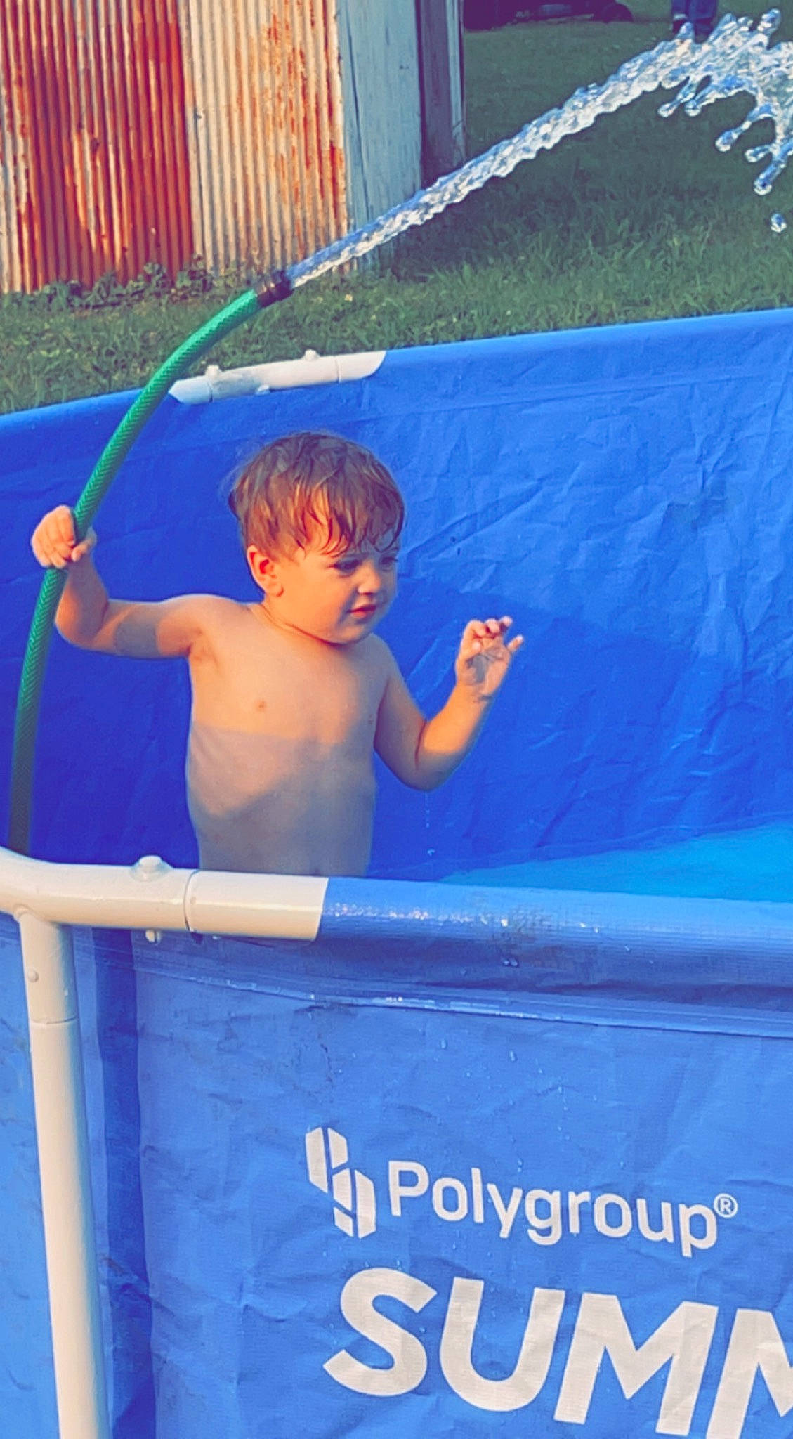 Karter is registered to the contest to win money with this photo: azure, barechested, blue, board_short, boats_and_boating_equipment_and_supplies, child, elbow, electric_blue, fun, games, grass, inflatable, leisure, person, play, recreation, shorts, t_shirt, toddler, vacation