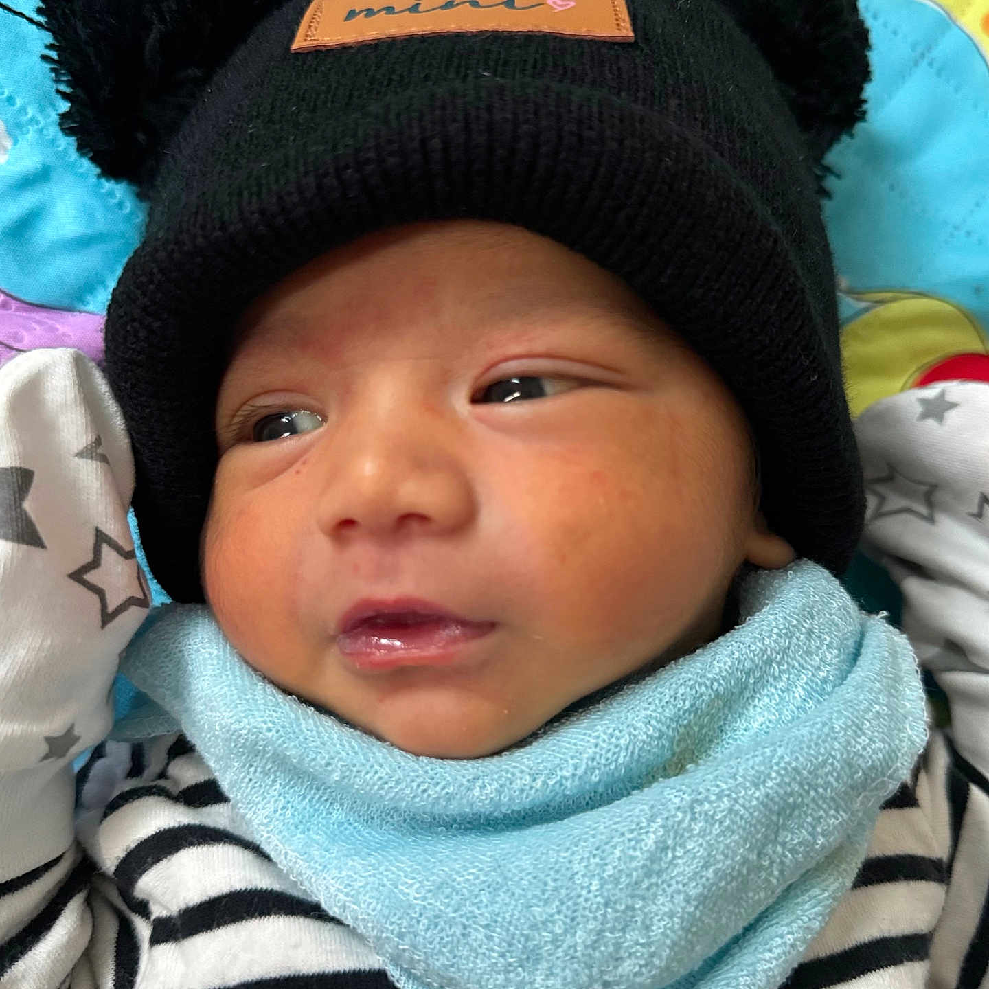 Md Shamil joined the competition — help win amazing prizes! adorable, baby, blanket, blue_bib, child, close_up, cute, face, hat, indoor, infant, knit_hat, newborn, patterned_blanket, pom_poms, resting, soft_texture, striped_clothing, warm_clothing, young
