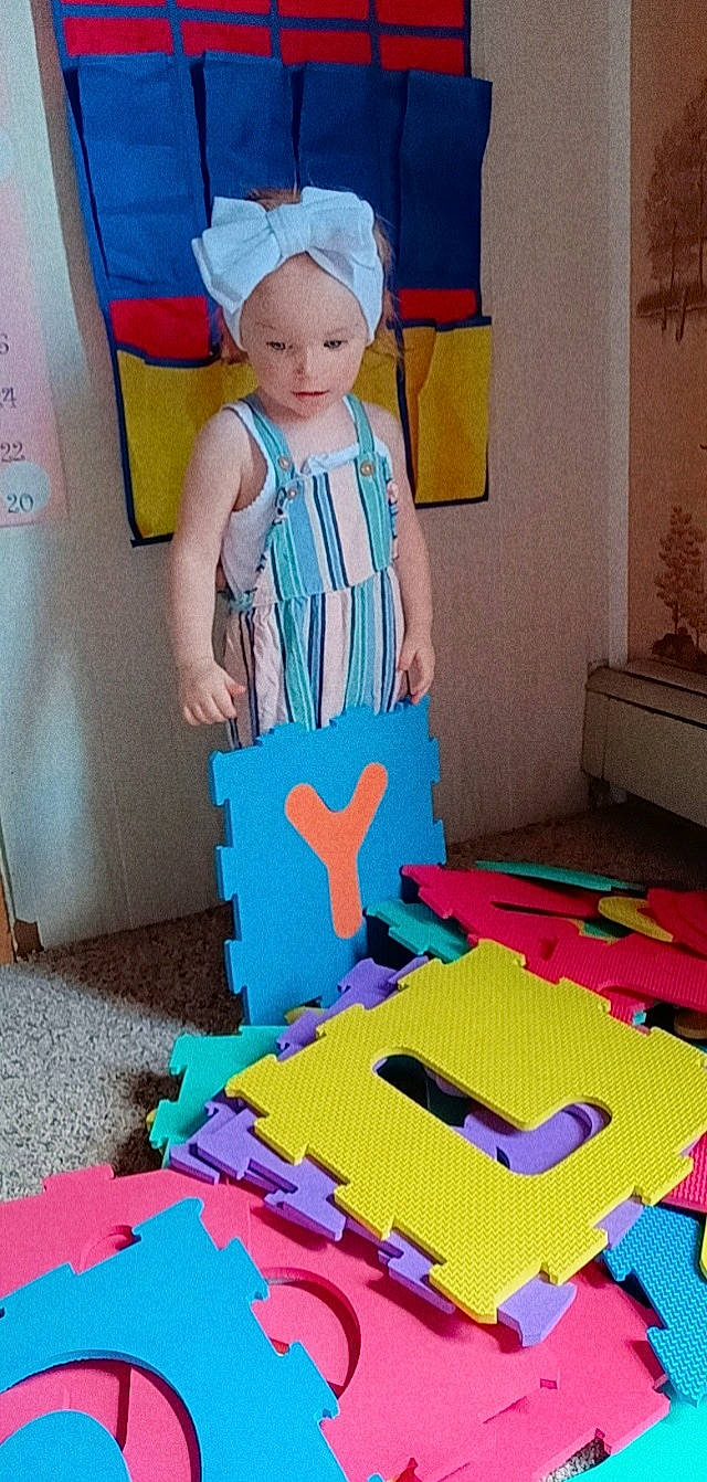 Mkenna is registered to the contest to win money with this photo: art, baby_toddler_clothing, child, electric_blue, fashion_design, flooring, fun, houseplant, linens, magenta, paint, pattern, person, pink, room, t_shirt, textile, toddler, visual_arts, wood