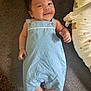 Casey is registered to the contest to win money with this photo: baby, infant, smiling, blue_romper, lying_down, cute, teddy_bear_pillow, cozy, indoor, child, adorable, portrait, soft_fabric, happy, skin, hand, foot, face, head, person
