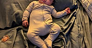 Noah joined the competition — help win amazing prizes! baby, sleeping, infant, child, bed, bedroom, pillow, blanket, bedsheets, onesie, clothing, pacifier, remote_control, portrait, indoors, furniture, relaxed, peaceful, nap, cozy