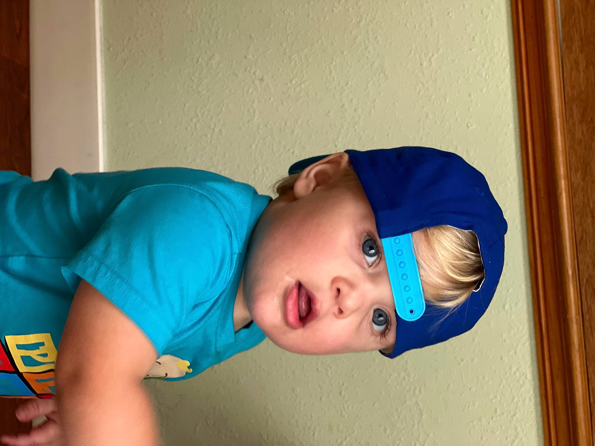 Landyn is registered to the contest to win money with this photo: abdomen, baby, baby_toddler_clothing, cap, cheek, chest, child, elbow, electric_blue, flooring, fun, hat, headgear, leisure, nose, person, room, sitting, sleeve, surprise