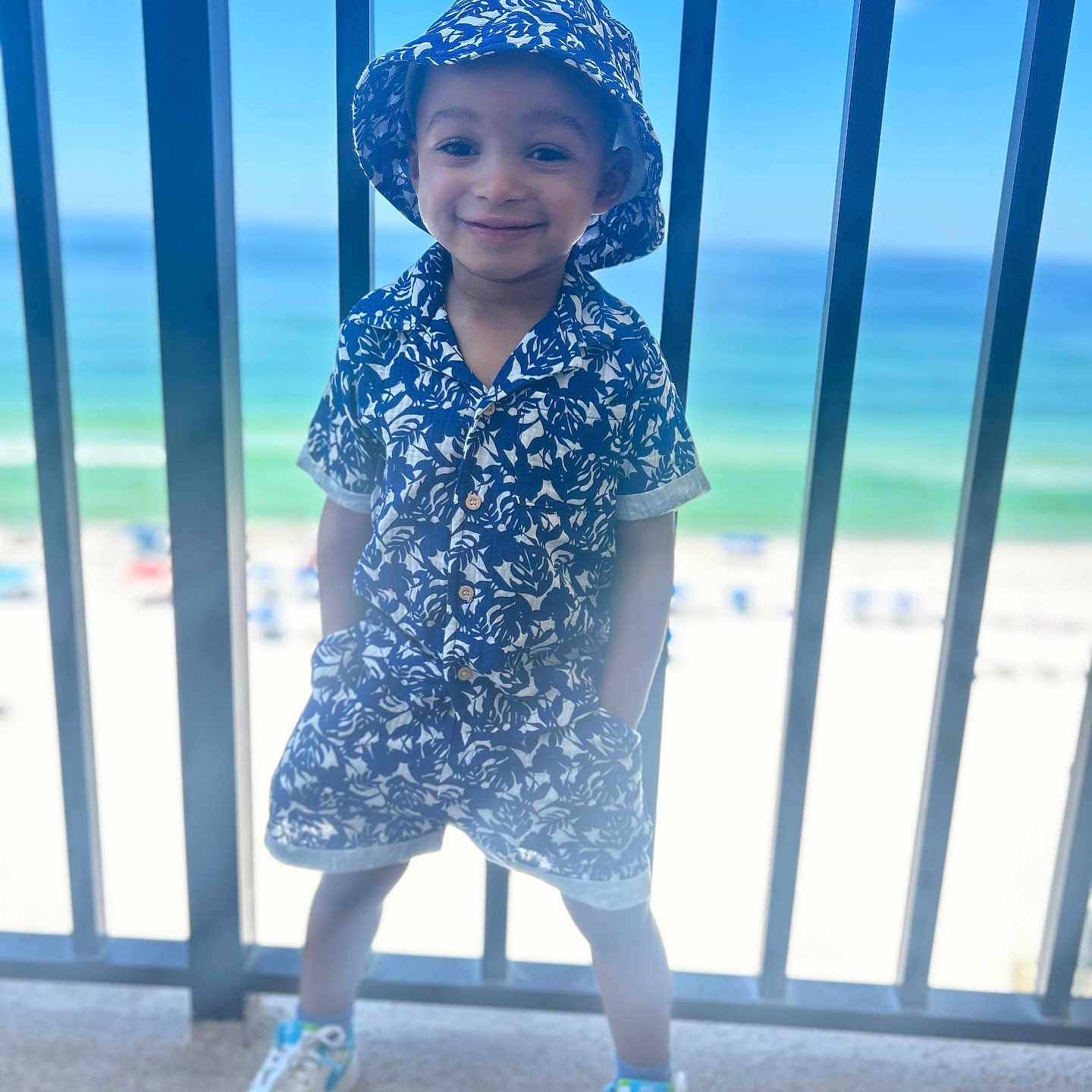 Donald is registered to the contest to win money with this photo: architecture, beachwear, boy, child, clothing, dress, face, footwear, hat, head, male, pants, person, photography, portrait, shoe, shorts, sleeve, sneaker, sunhat