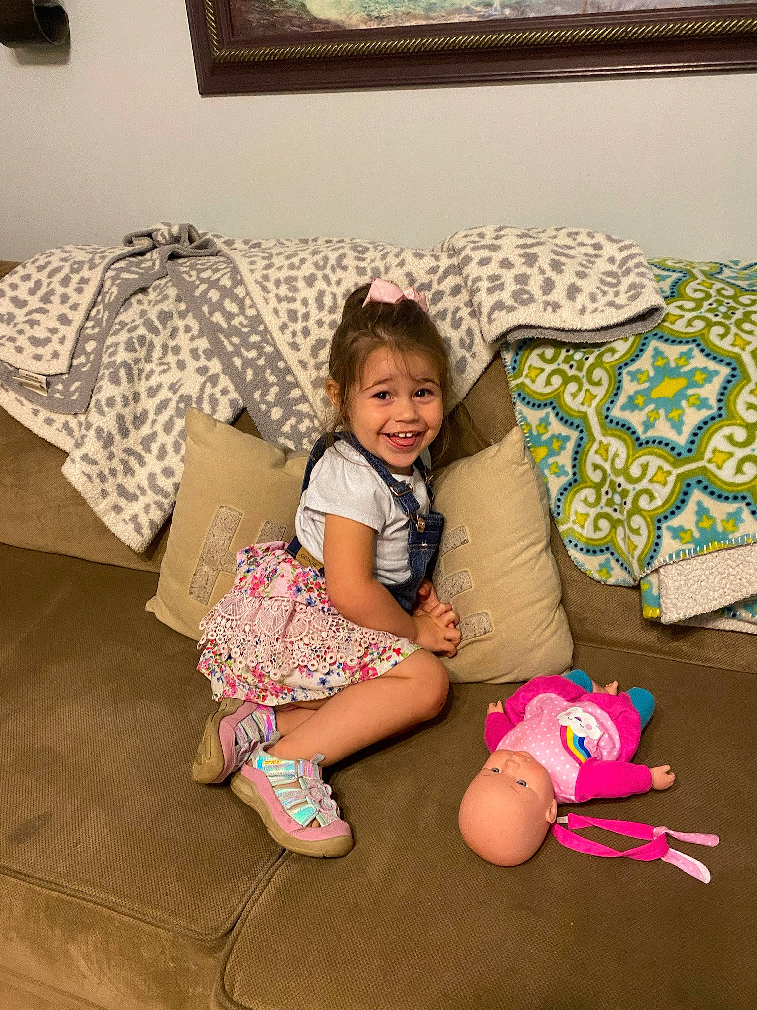Charlee joined the competition — help win amazing prizes! baby_toddler_clothing, comfort, couch, face, floor, flooring, happy, head, joy, knee, lap, leg, leisure, living_room, person, picture_frame, pillow, smile, sock, textile