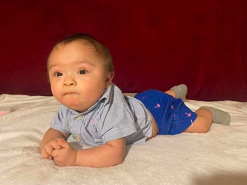 Valentin is registered to the contest to win money with this photo: baby, baby_toddler_clothing, cheek, child, comfort, crawling, flash_photography, flooring, fun, happy, hardwood, linens, nose, person, sitting, skin, sleeve, smile, toddler, tummy_time