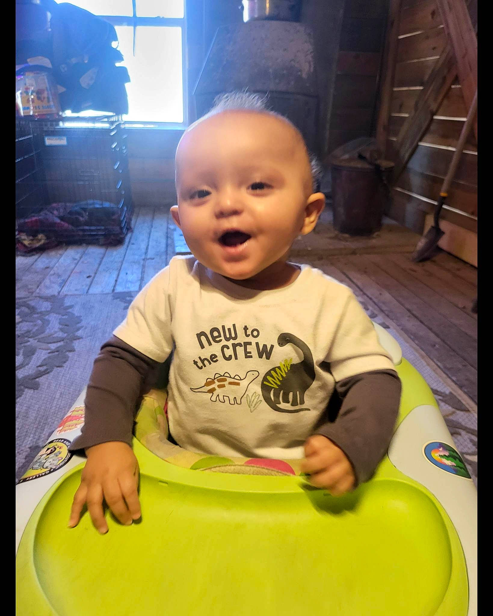 Keon is registered to the contest to win money with this photo: baby, baby_toddler_clothing, black, child, circle, eye, flooring, fun, happy, leisure, person, play, recreation, room, sitting, sleeve, smile, t_shirt, toddler, window