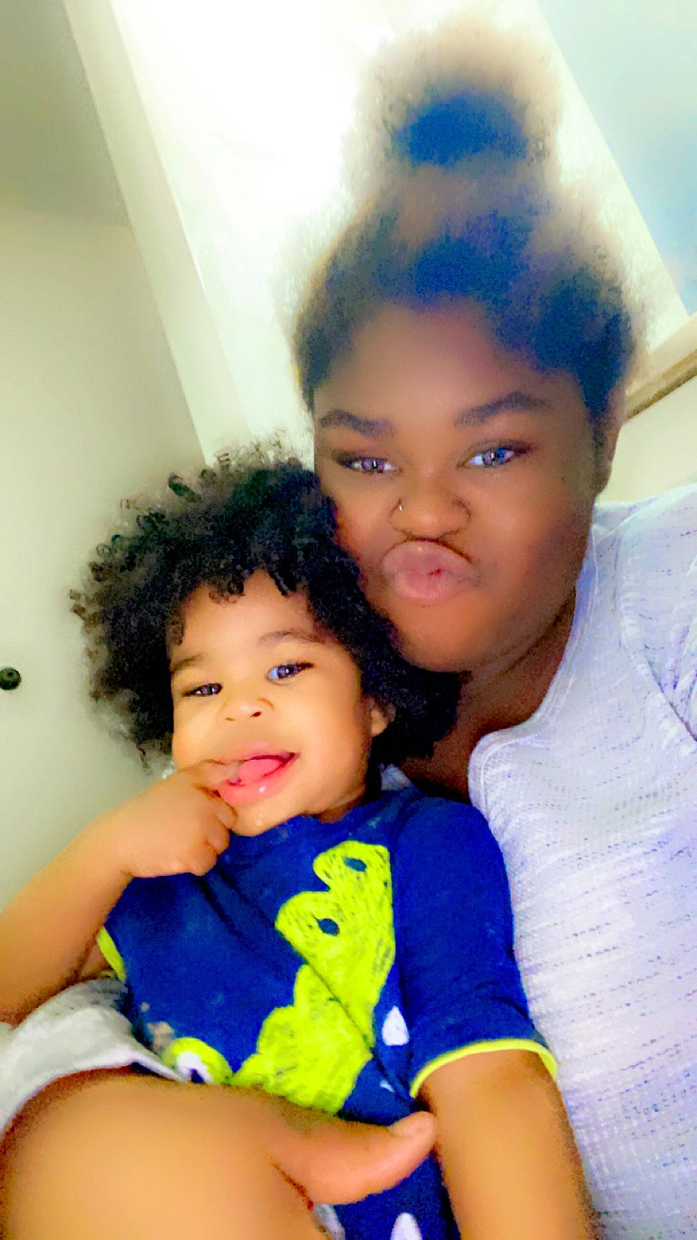 Legend is registered to the contest to win money with this photo: afro, azure, baby_toddler_clothing, black_hair, cheek, child, chin, event, facial_expression, fun, gesture, happy, hug, iris, lip, nose, person, sitting, skin, t_shirt