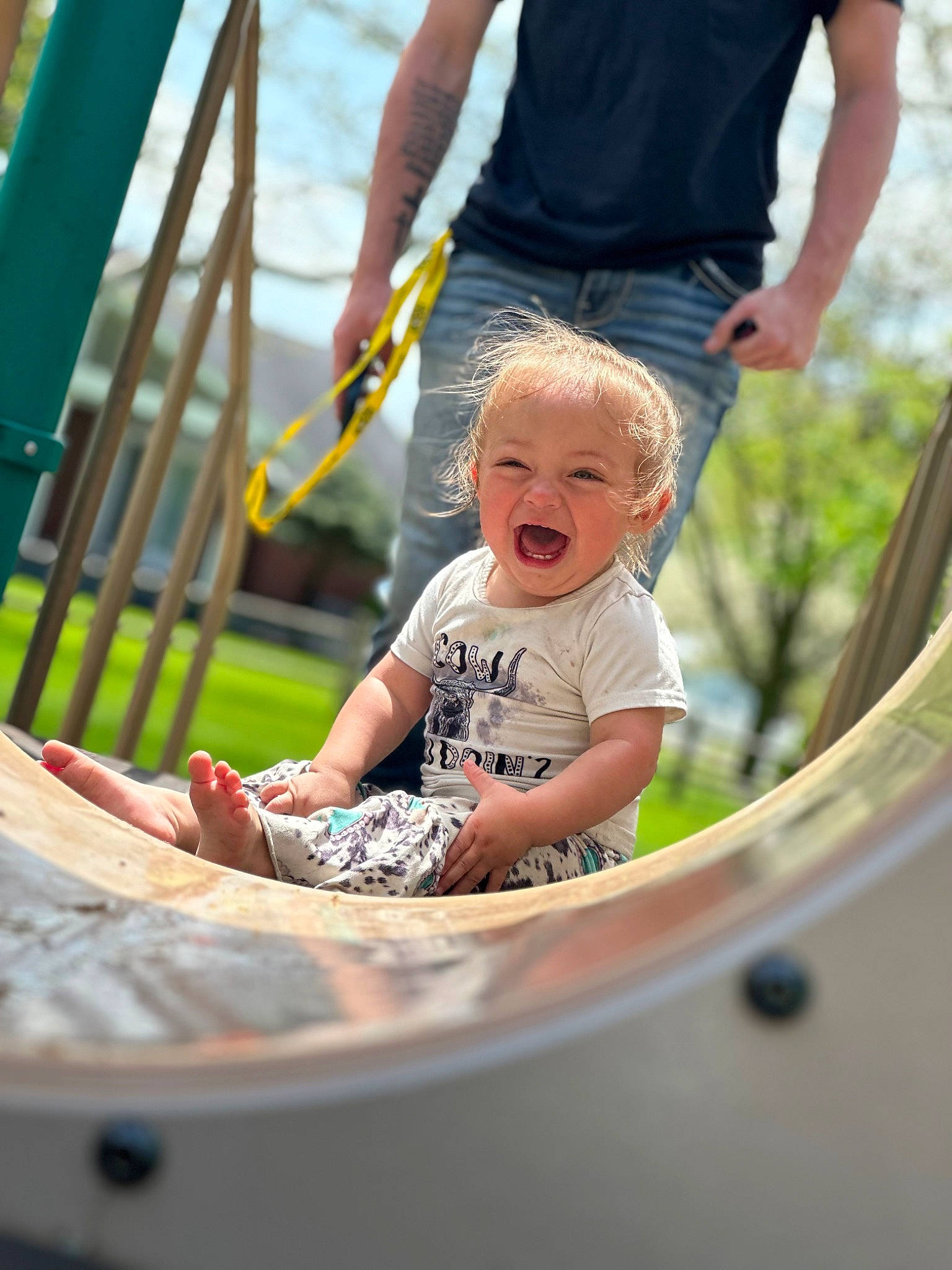 Kinzley joined the competition — help win amazing prizes! arm, baby, belt, child, city, fun, grass, happy, leisure, outdoor_play_equipment, people, person, play, recreation, shorts, sitting, smile, t_shirt, toddler, tree