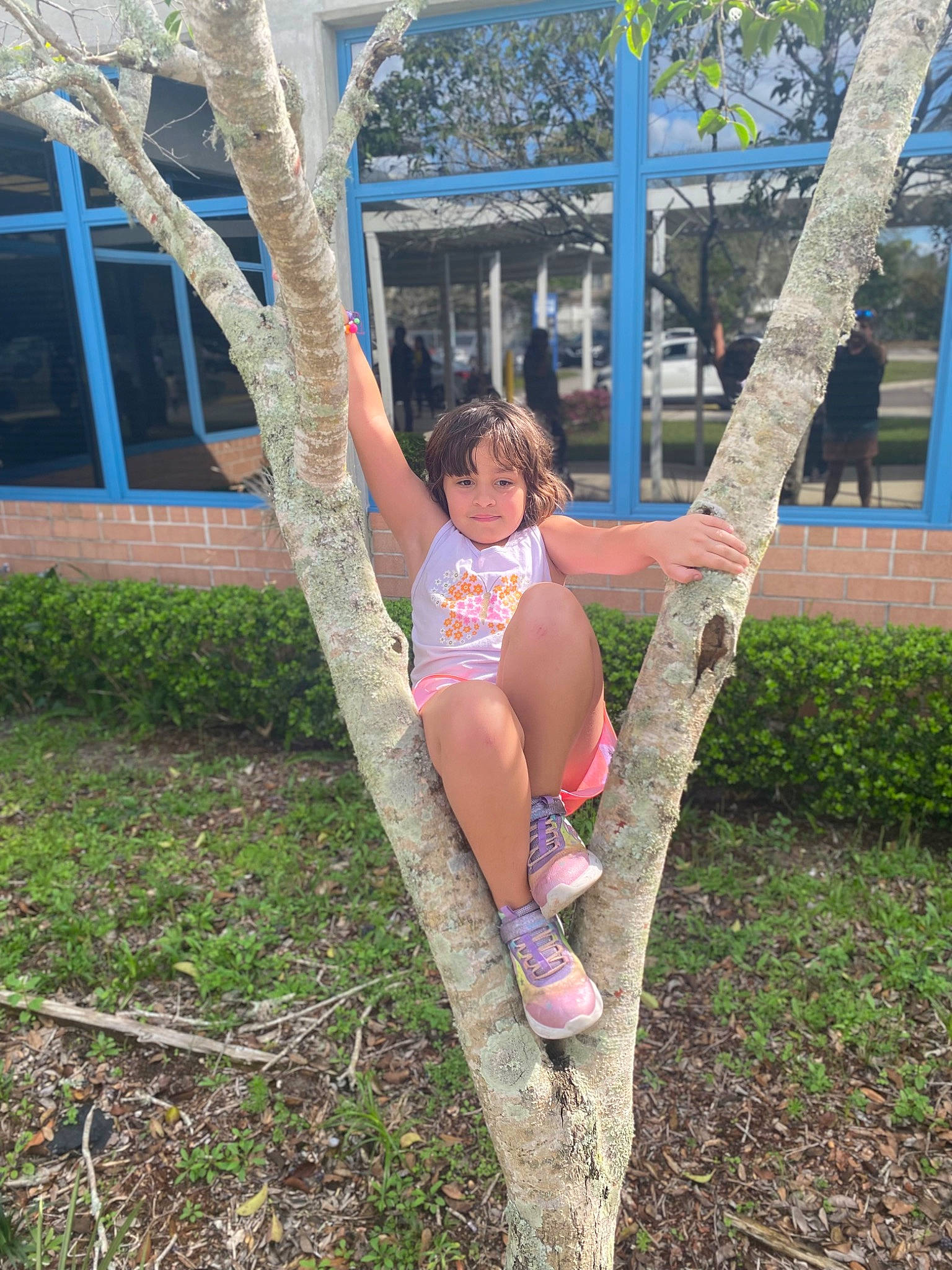 Penelope Rose is registered to the contest to win money with this photo: boot, foot, fun, grass, happy, human_body, human_leg, knee, leisure, magenta, people_in_nature, person, plant, shorts, sitting, t_shirt, thigh, tree, trunk, waist