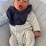 Liam participe au concours pour gagner de l'argent avec cette photo : baby, infant, onesie, bib, cushion, striped, bed, blanket, sleepwear, comfort, lying_down, indoors, cute, expression, child, small, person, soft, resting, cozy