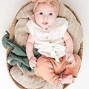 Enaé participe au concours pour gagner de l'argent avec cette photo : baby, infant, basket, blanket, headband, bow, clothing, white_background, plush_toy, cute, soft_texture, child, portrait, sitting, indoors, happy, small_feet, buttoned_shirt, cozy, closeup