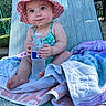 baby, child, sunhat, water_bottle, towel, lounge_chair, outdoor, summer, swimsuit, cute, sitting, skin, feet, hand, daylight, relaxation, expression, portrait, infant, vacation