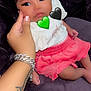 Lydia joined the competition — help win amazing prizes! baby, black_heart, bracelet, child, couch, cute, green_heart, hand, heart_emoji, indoors, infant, person, pink_skirt, plush, portrait, purple_couch, sitting, skin, tattoo, white_top