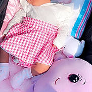Lydia is registered to the contest to win money with this photo: baby, sleeping, pink, blanket, plush_toy, soft_toy, infant, cute, child, resting, clothing, white_top, patterned_skirt, sock, indoor, peaceful, portrait, comfort, toddler, toy