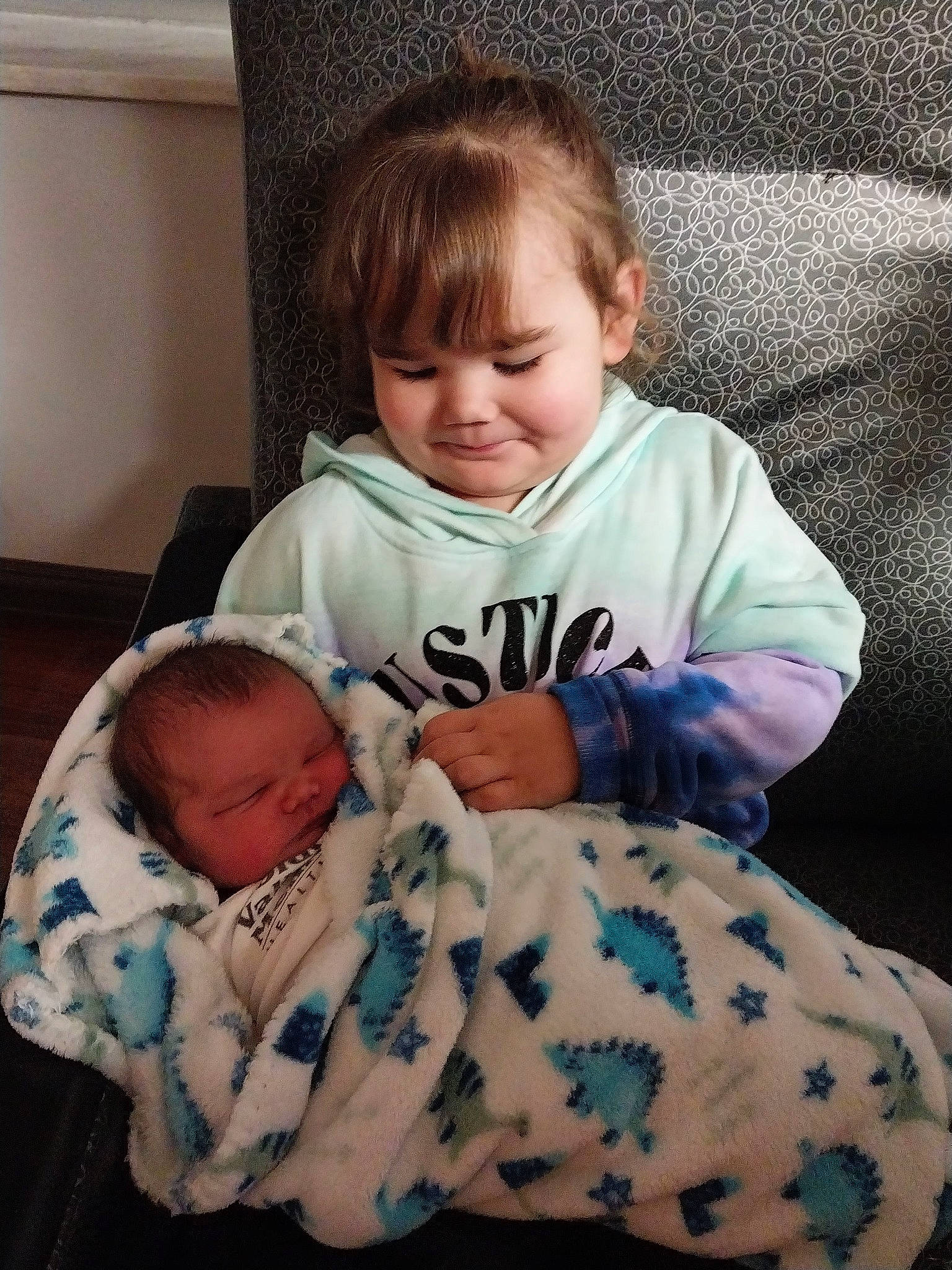 Kingston is registered to the contest to win money with this photo: arm, baby, baby_toddler_clothing, cheek, child, comfort, eye, face, facial_expression, hairstyle, human_body, iris, joy, linens, nose, person, sitting, skin, sleeve, standing