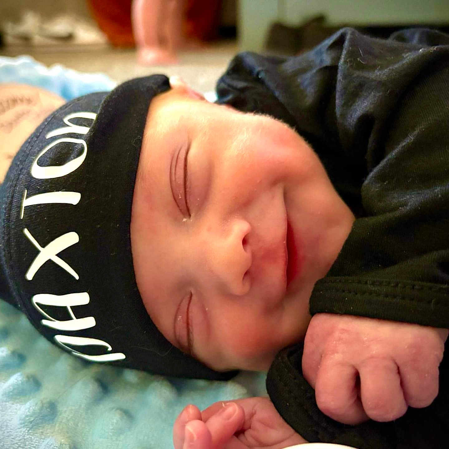 Daxton joined the competition — help win amazing prizes! baby, beanie, blanket, bodypart, bonnet, cap, clothing, coat, face, finger, glove, hand, hat, head, jacket, newborn, person, photography, portrait, sleeping