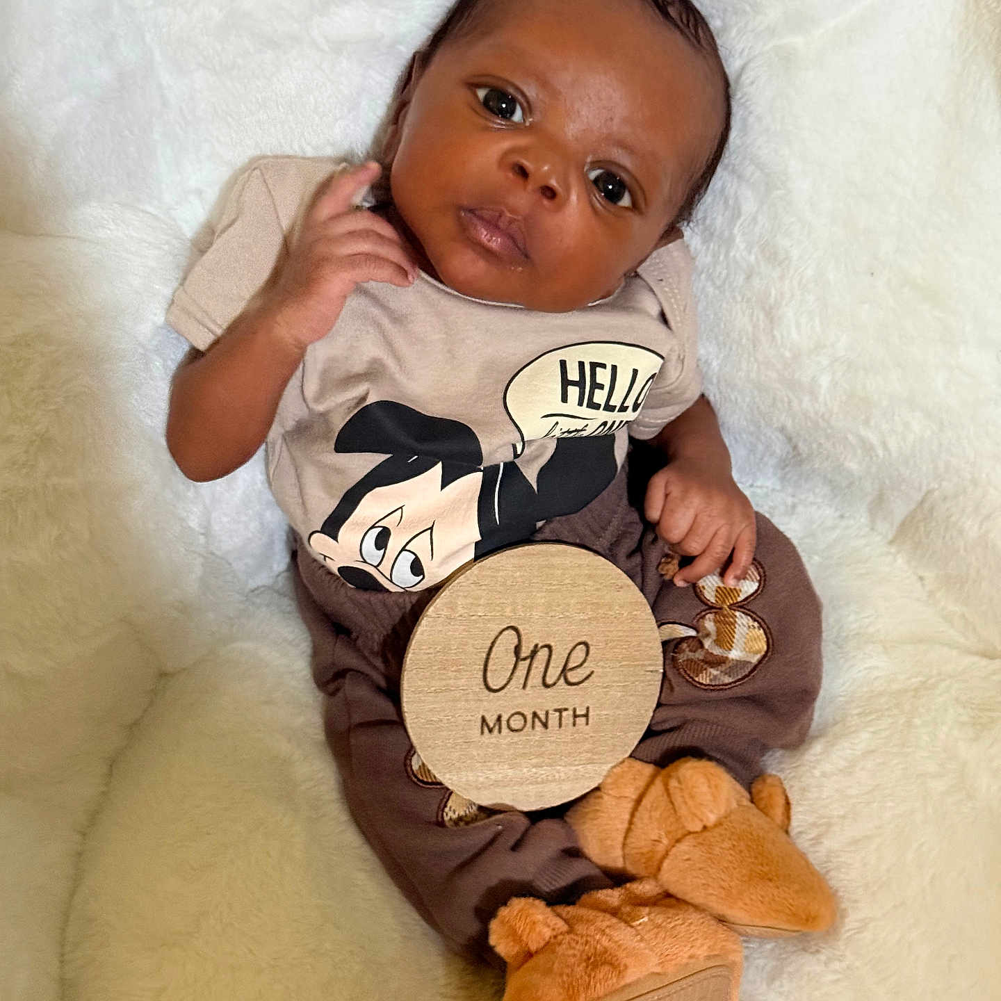 Jamier joined the competition — help win amazing prizes! baby, infant, one_month, mickey_mouse, clothing, blanket, soft, cute, portrait, child, milestone, wooden_sign, fur_booties, lying_down, indoors, young, face, hand, expression, cozy